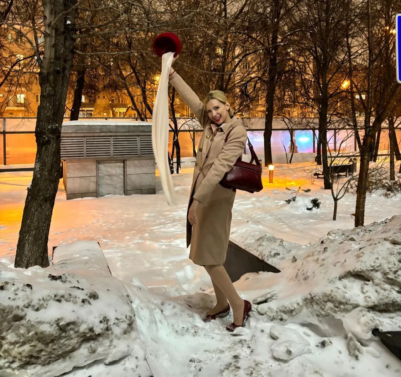 Safae in a camel coat, arm raised in the snow — from dream to reality